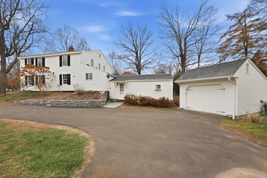 Paved private driveway with detached 1-car garage.