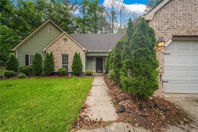 View of front of home with a front lawn, a shingle