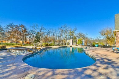 Pool with a patio and an in ground hot tub