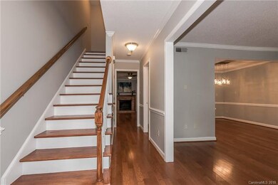 Entry foyer; wood stairs leading to second floor