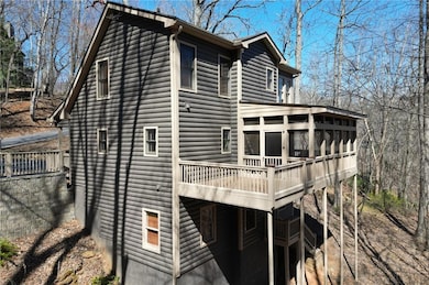 View of home's exterior featuring a deck, faux log