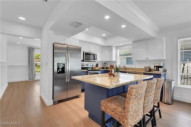 Kitchen with plenty of natural light, visible vent