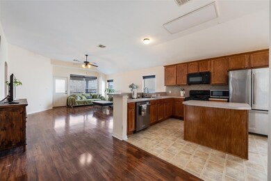 Kitchen with black appliances, light countertops,
