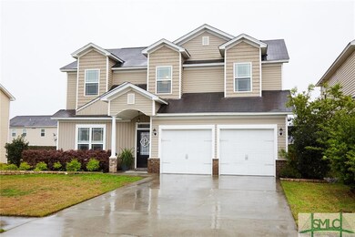 EXRERIOR FRONT: The two garage roll up doors have 