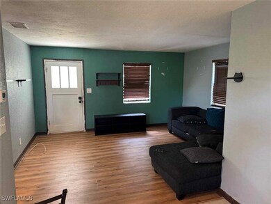 Foyer with visible vents, baseboards, wood finishe