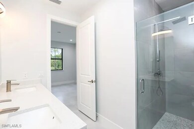 Bathroom featuring walk in shower and vanity