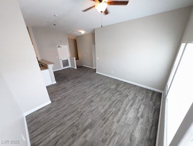 Unfurnished living room with a ceiling fan, wood f