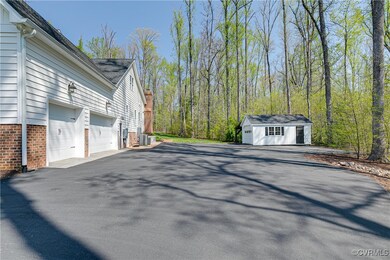 Attached 3-car garage, detached garage, and asphal
