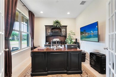 Den with double french doors in the front of the h