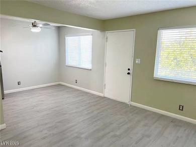 Entryway featuring ceiling fan, wood finished floo