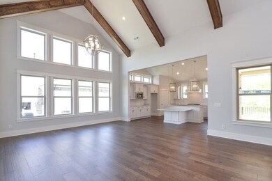 View of Great Room and Gourmet Kitchen. Lots of Windows with Natural Light.  This photo is not actual home. For representation purposes only. 