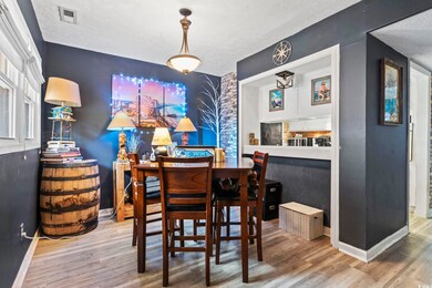 Dining area with a textured ceiling and hardwood /