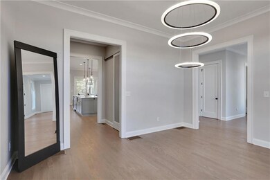 Unfurnished room with ornamental molding and light