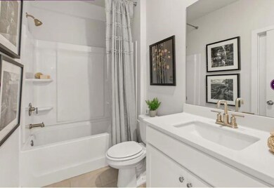 Bathroom with vanity, shower / bathtub combination with curtain, and tile patterned floors