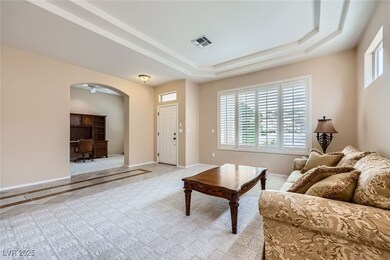 Living room featuring arched walkways, light tile