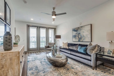 Living room featuring wood finished floors, a ceiling fan, and recessed lighting