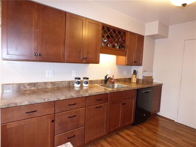 Kitchen - Wine rack above sink and trash drawer ne