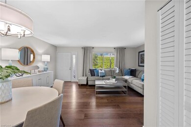 Living room with dark hardwood / wood-style floors