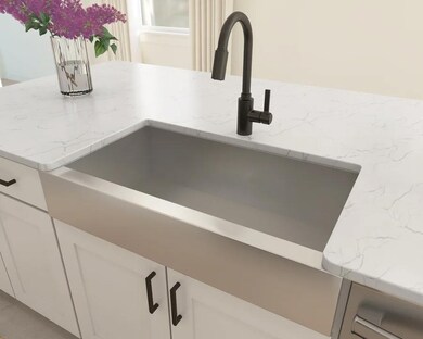 Stainless steel apron-front sink