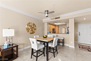 Dining room featuring crown molding and a ceiling fan