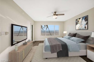 Bedroom featuring tile floors, dual closets, direct gulf views and ceiling fan - wake up to the views of the beach and gulf
