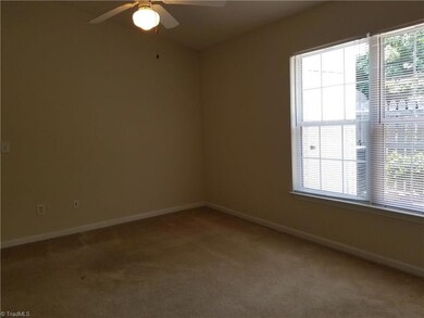 The master bedroom is located to the rear of the unit and overlooks the landscaped, fenced patio area. Features include a ceiling fan, two closets with one a walk-in, and a deluxe bathroom.