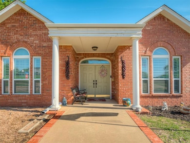 View of exterior entry featuring a porch and brick siding
