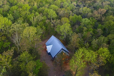 View of subject property with a forest