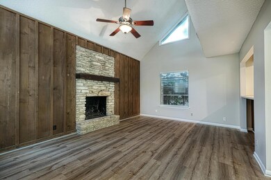 Unfurnished living room with ceiling fan, wood fi