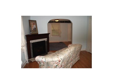 LIVING ROOM WITH FIREPLACE AND ADJOINING DINING RO