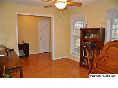 A VIEW OF THE DINING/STUDY/LIVING ROOM FROM THE DOOR TO THE KITCHEN.