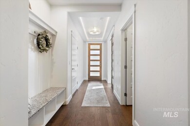 Mudroom with dark wood-type flooring and baseboards