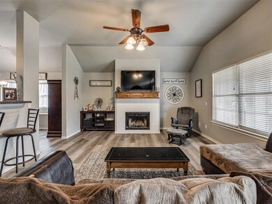 Living room with wood-type flooring, vaulted ceili