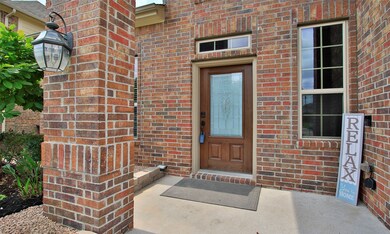The all brick entry is covered.   There is a look doorbell that staying with the home.