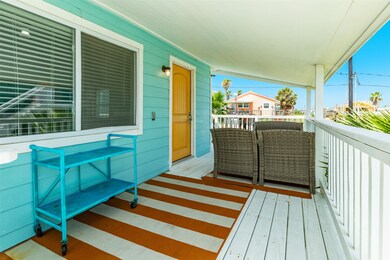 This charming porch features a vibrant turquoise e