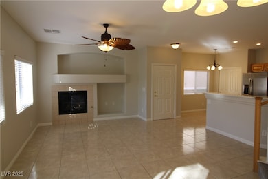Unfurnished living room featuring a tiled fireplac