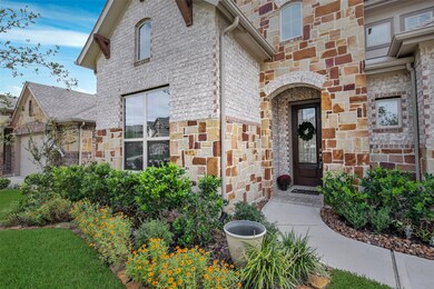 Welcoming, covered front porch with brick surround and beautiful 8-foot front door - perfect setting to greet your guests!