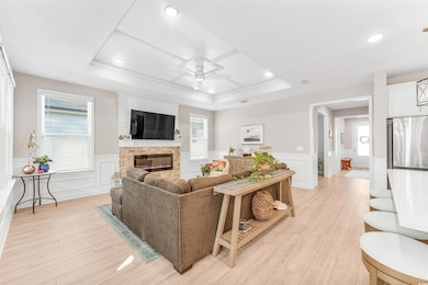 Living room with light wood finished floors, a rai
