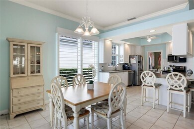 Dining area featuring crown molding, light tile pa