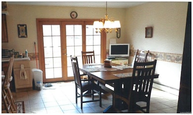 Eating area boasts french doors to deck.