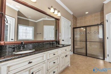 Large glamour bath with tub and shower and walk in closet.  His and her sinks and tile.