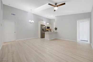Unfurnished living room with a chandelier, a ceili