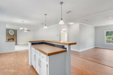 Kitchen with decorative light fixtures, ceiling fa