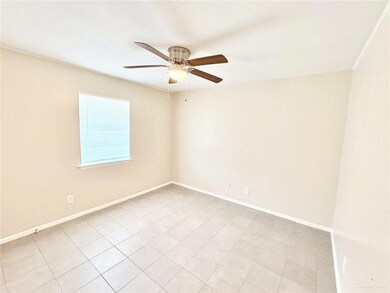 Unfurnished room featuring ceiling fan and light tile patterned flooring