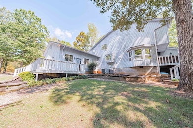 Back of property with a lawn and a deck