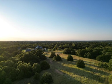 Aerial view at dusk featuring a rural view