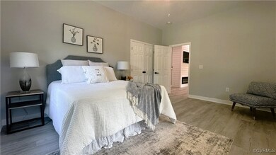 Bedroom featuring light hardwood / wood-style floo
