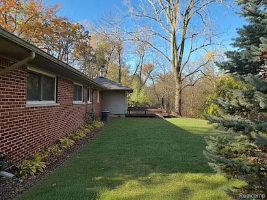 View of green lawn with a wooden deck