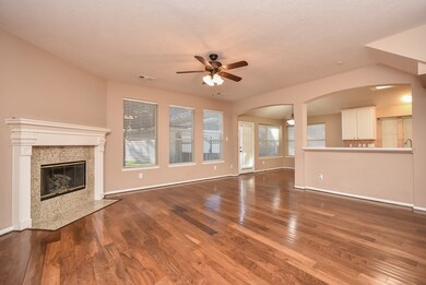 Spacious family room has hand scraped walnut wood floors and fireplace with lovely mantle.