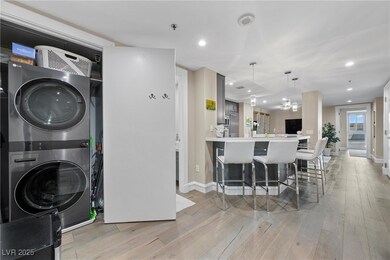 Clothes washing area with light wood-type flooring